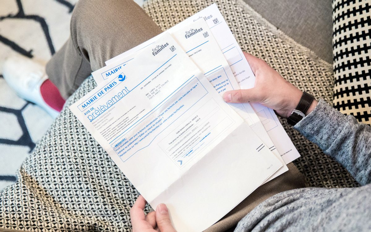 Parent consultant son espace famille Paris Familles sur un ordinateur
